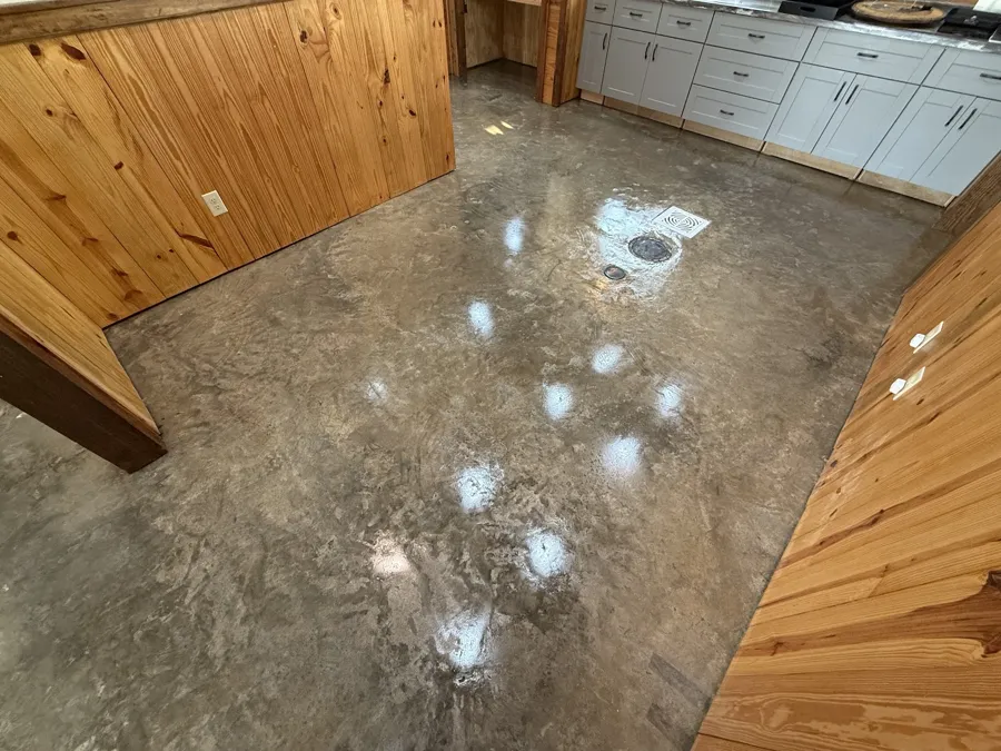 Metallic epoxy floor in a pine-walled camp kitchen
