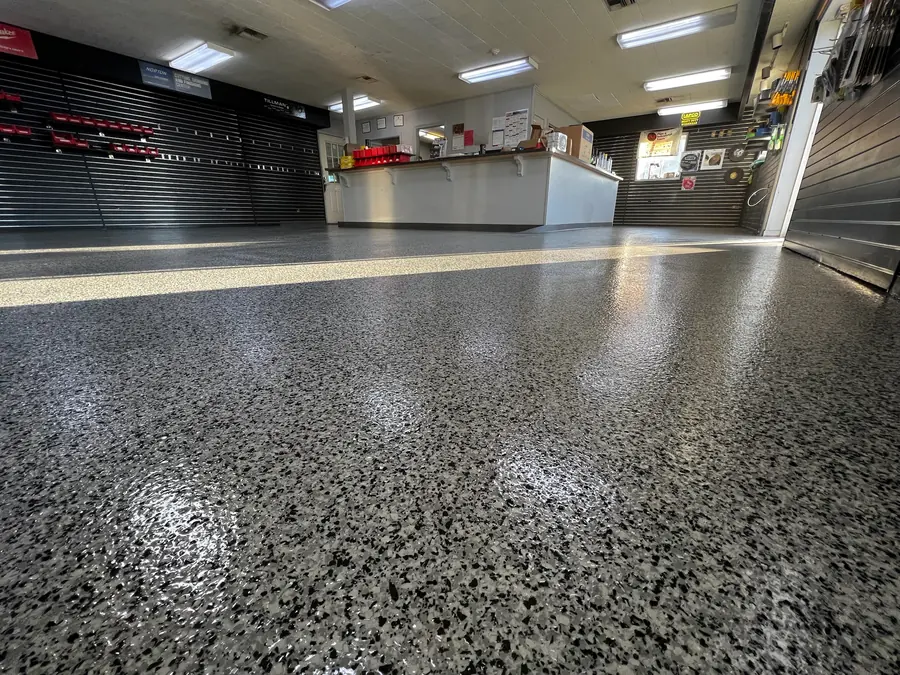 Retail counter area finished in glossy black and grey flake