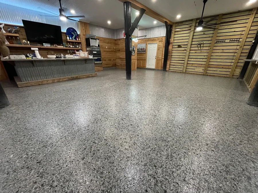 Grey flake floor in a pine-walled room with a slatted accent wall