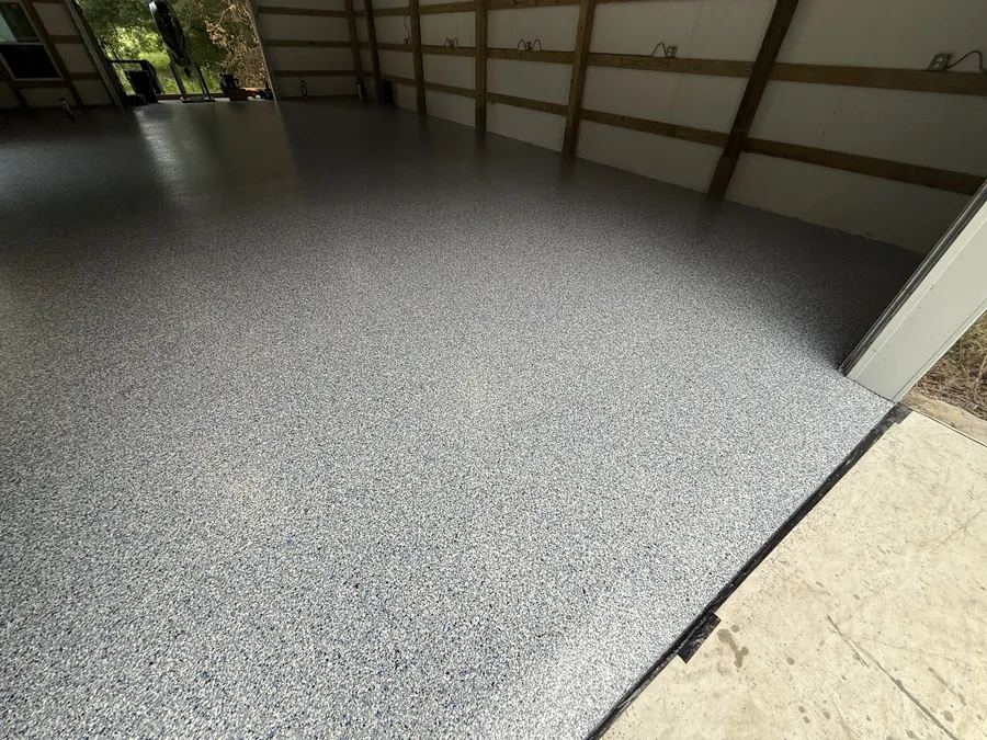 Full barn floor coated in grey flake from wall to wall