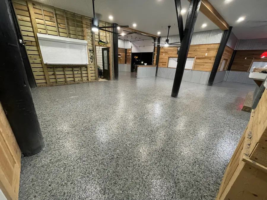 Flake floor along the windows of a long pine and tin room