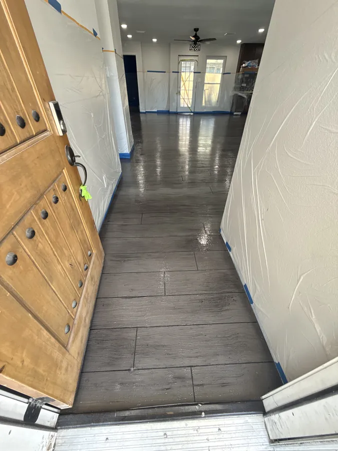 Dark wood plank overlay running down a front hallway