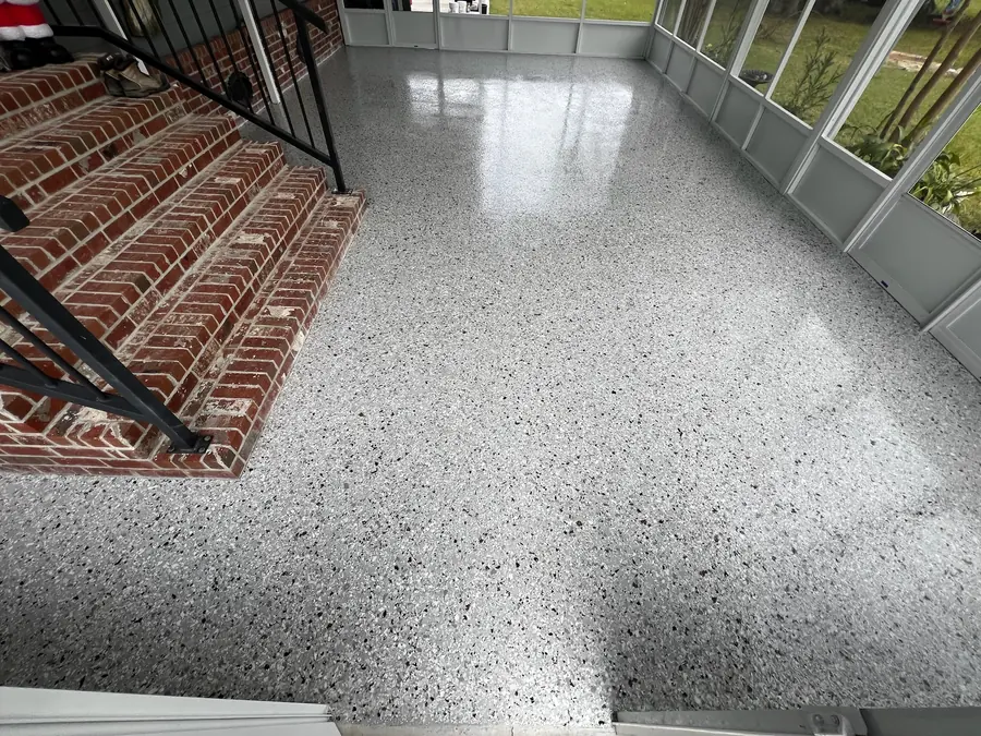Screened porch in grey flake beside brick steps