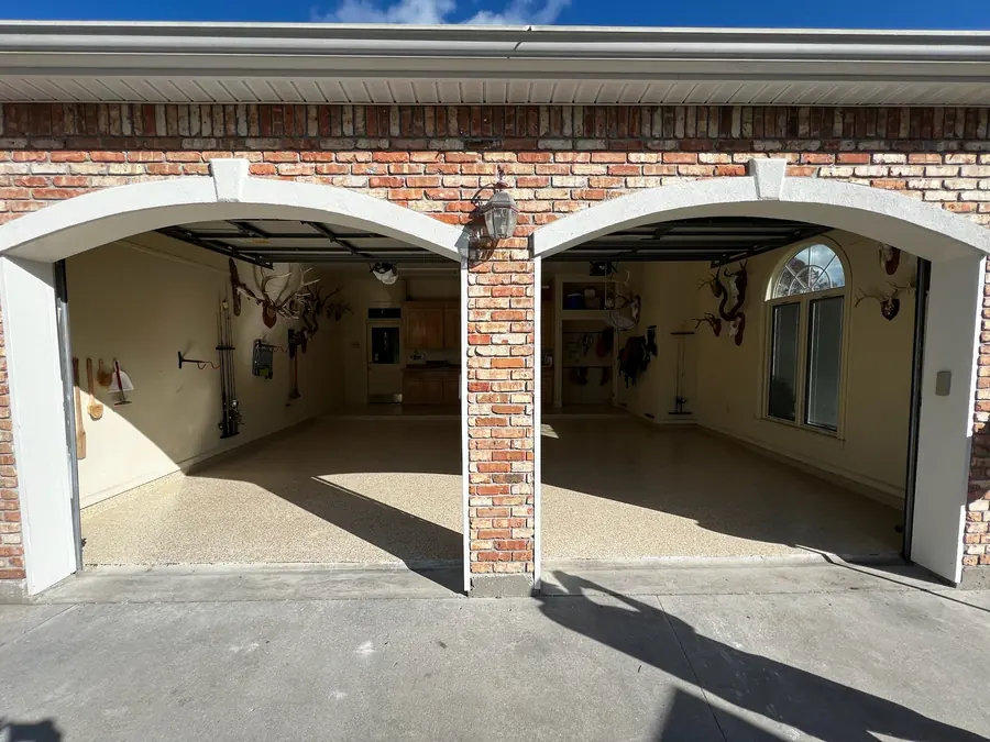 Double-arch garage after its tan flake floor