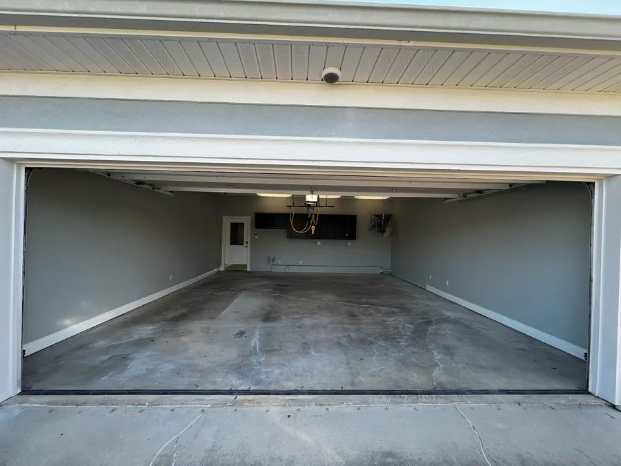 Bare, stained two-car garage slab before coating