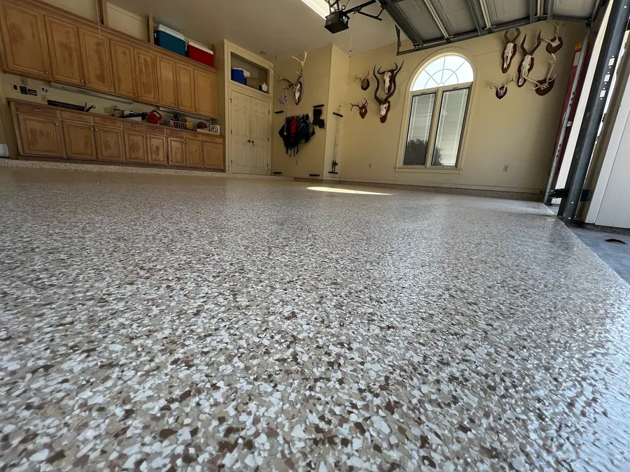 Tan flake garage floor with trophy mounts on the wall