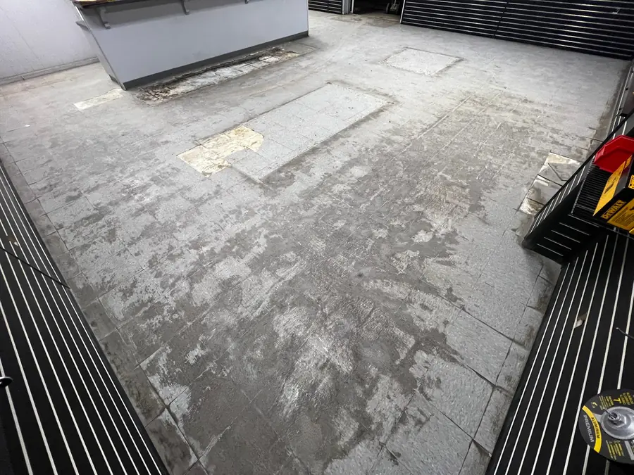 Retail floor mid-prep with the old coating ground off